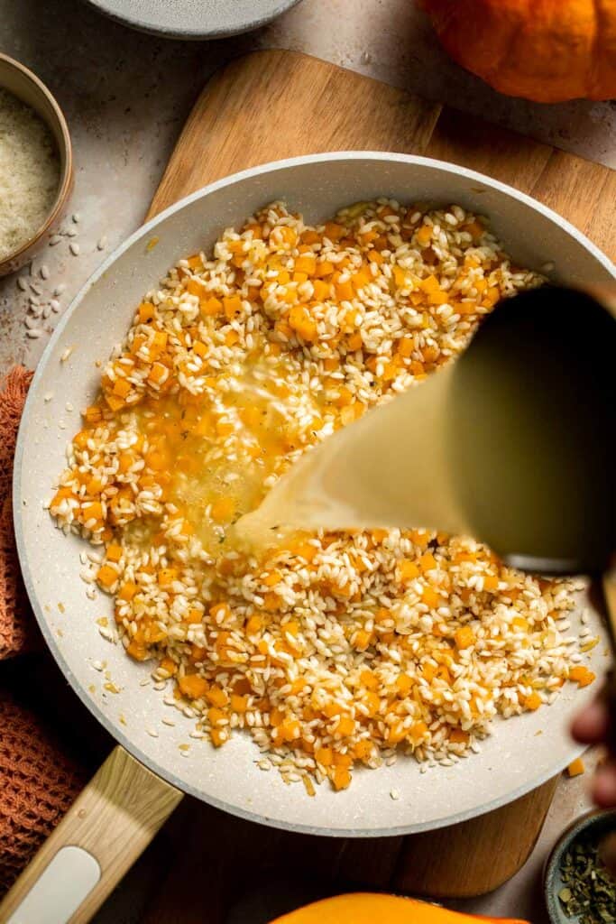 Enjoy a taste of fall with this creamy pumpkin risotto made with arborio rice, savory pumpkin, and aromatic herbs for a cozy, flavorful dish. | aheadofthyme.com