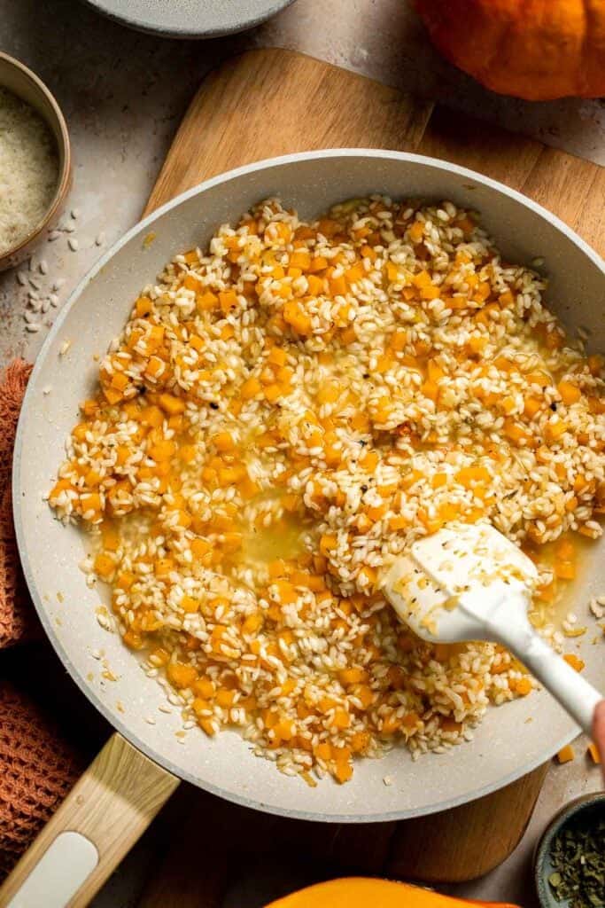 Enjoy a taste of fall with this creamy pumpkin risotto made with arborio rice, savory pumpkin, and aromatic herbs for a cozy, flavorful dish. | aheadofthyme.com