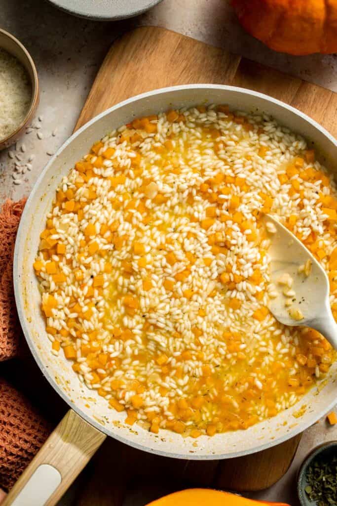 Enjoy a taste of fall with this creamy pumpkin risotto made with arborio rice, savory pumpkin, and aromatic herbs for a cozy, flavorful dish. | aheadofthyme.com