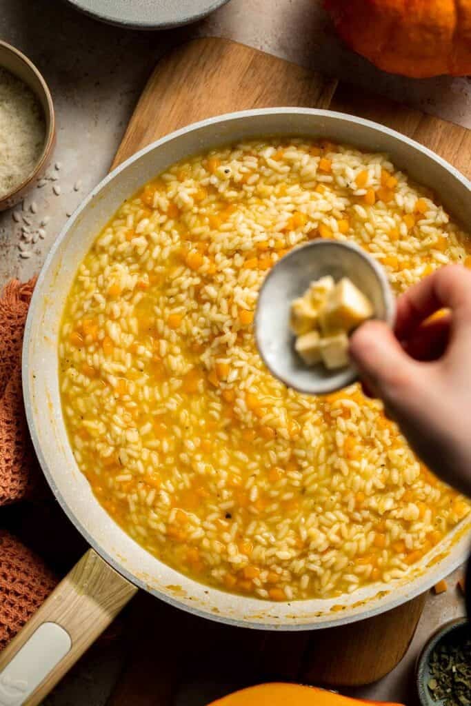 Enjoy a taste of fall with this creamy pumpkin risotto made with arborio rice, savory pumpkin, and aromatic herbs for a cozy, flavorful dish. | aheadofthyme.com