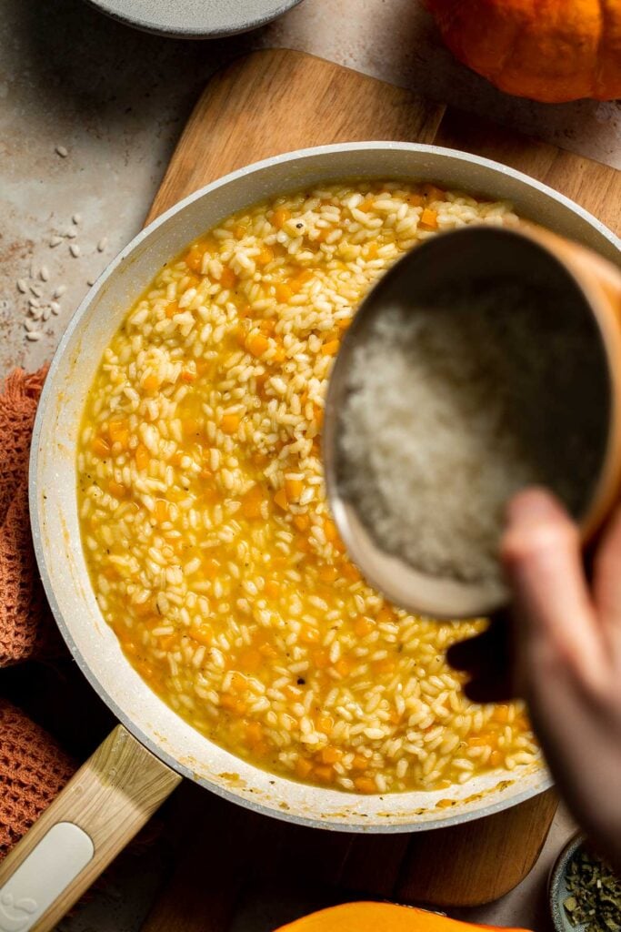 Enjoy a taste of fall with this creamy pumpkin risotto made with arborio rice, savory pumpkin, and aromatic herbs for a cozy, flavorful dish. | aheadofthyme.com