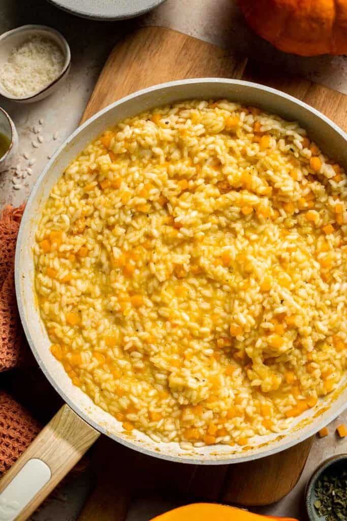Enjoy a taste of fall with this creamy pumpkin risotto made with arborio rice, savory pumpkin, and aromatic herbs for a cozy, flavorful dish. | aheadofthyme.com