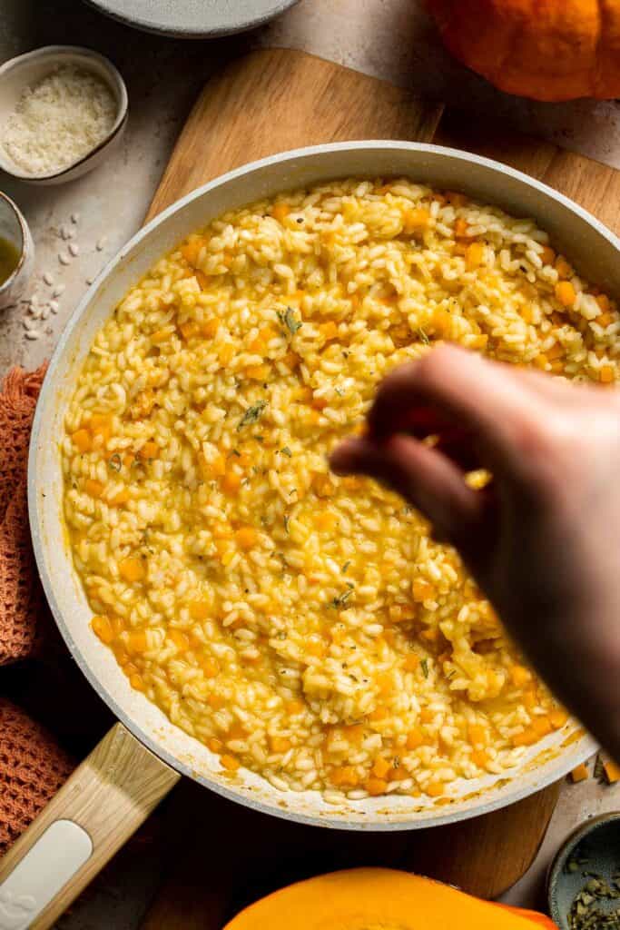 Enjoy a taste of fall with this creamy pumpkin risotto made with arborio rice, savory pumpkin, and aromatic herbs for a cozy, flavorful dish. | aheadofthyme.com