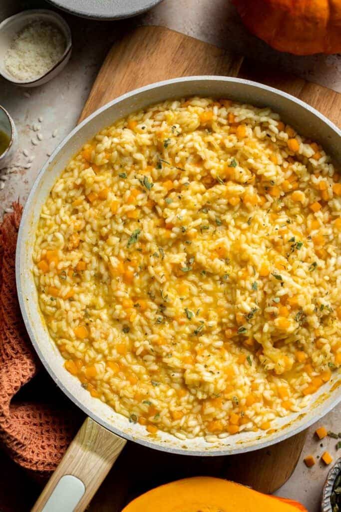 Enjoy a taste of fall with this creamy pumpkin risotto made with arborio rice, savory pumpkin, and aromatic herbs for a cozy, flavorful dish. | aheadofthyme.com