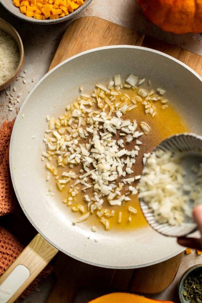 Enjoy a taste of fall with this creamy pumpkin risotto made with arborio rice, savory pumpkin, and aromatic herbs for a cozy, flavorful dish. | aheadofthyme.com