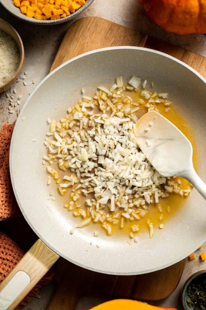 Enjoy a taste of fall with this creamy pumpkin risotto made with arborio rice, savory pumpkin, and aromatic herbs for a cozy, flavorful dish. | aheadofthyme.com