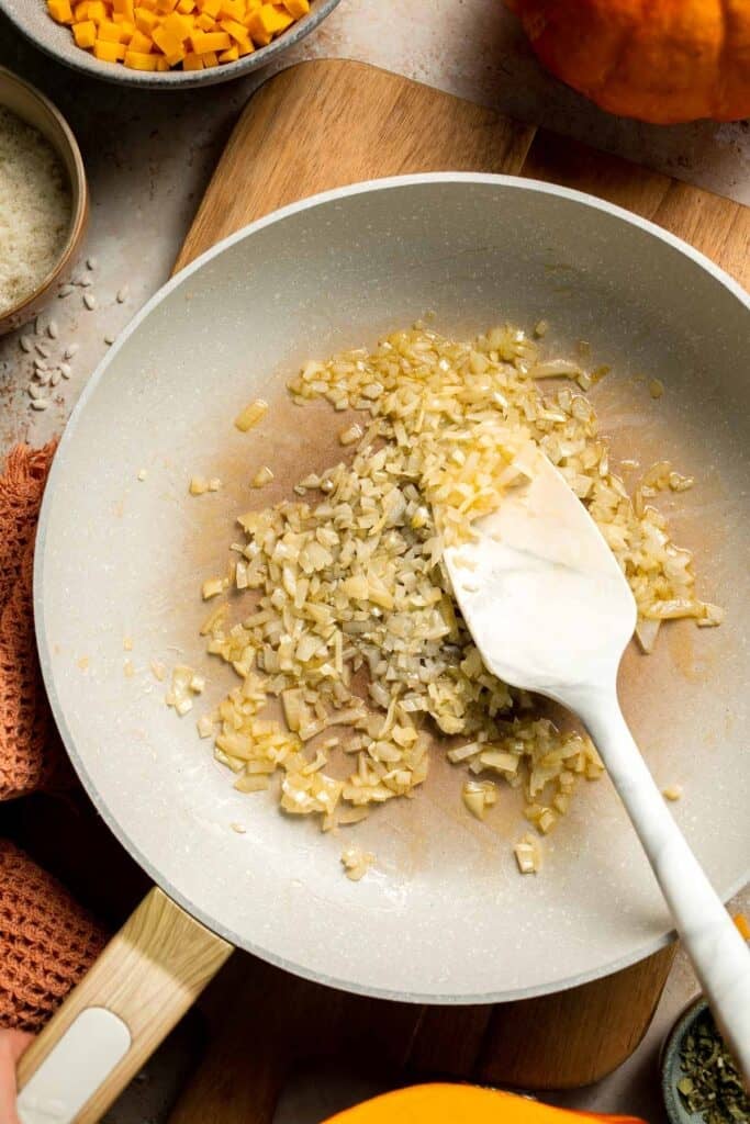 Enjoy a taste of fall with this creamy pumpkin risotto made with arborio rice, savory pumpkin, and aromatic herbs for a cozy, flavorful dish. | aheadofthyme.com