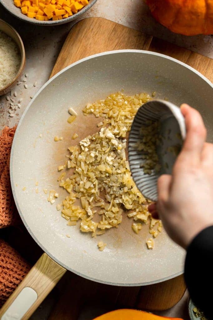 Enjoy a taste of fall with this creamy pumpkin risotto made with arborio rice, savory pumpkin, and aromatic herbs for a cozy, flavorful dish. | aheadofthyme.com
