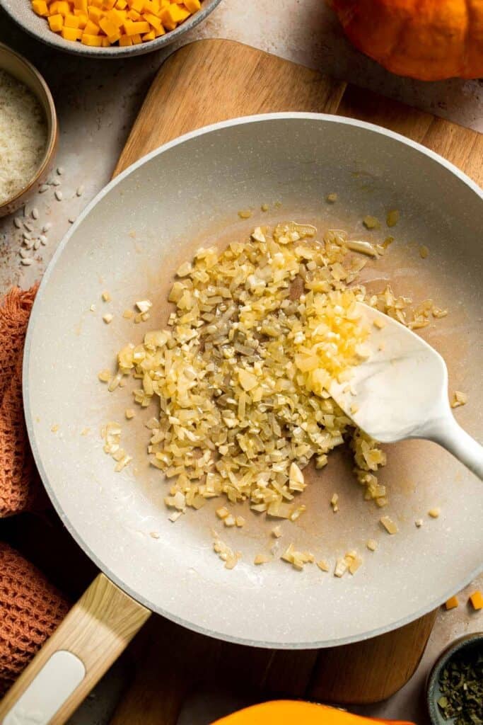 Enjoy a taste of fall with this creamy pumpkin risotto made with arborio rice, savory pumpkin, and aromatic herbs for a cozy, flavorful dish. | aheadofthyme.com