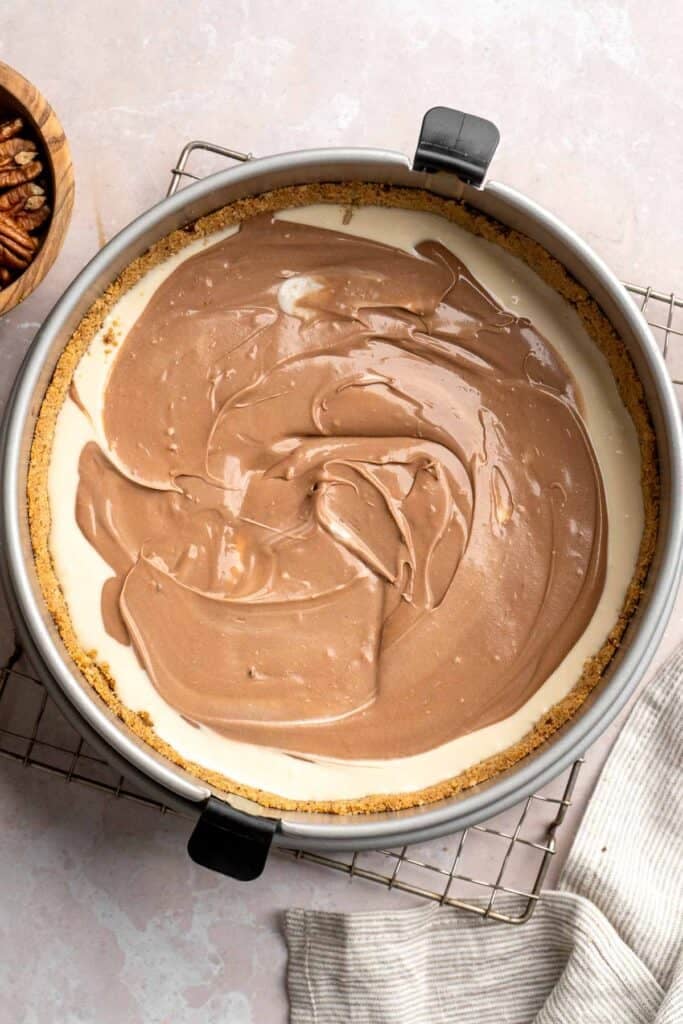 Rich and creamy Turtle Cheesecake with caramel, chocolate, and pecans is a decadent baked dessert with a buttery graham crust and silky filling. | aheadofthyme.com
