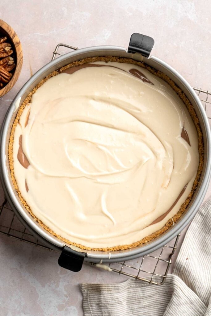 Rich and creamy Turtle Cheesecake with caramel, chocolate, and pecans is a decadent baked dessert with a buttery graham crust and silky filling. | aheadofthyme.com