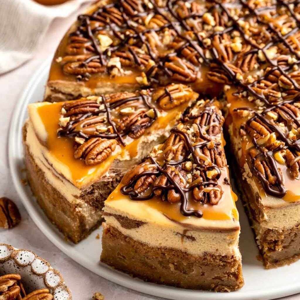 Rich and creamy Turtle Cheesecake with caramel, chocolate, and pecans is a decadent baked dessert with a buttery graham crust and silky filling. | aheadofthyme.com