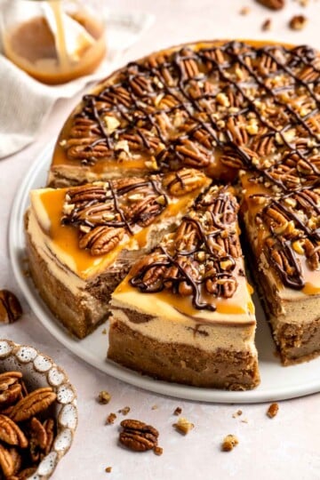 Rich and creamy Turtle Cheesecake with caramel, chocolate, and pecans is a decadent baked dessert with a buttery graham crust and silky filling. | aheadofthyme.com