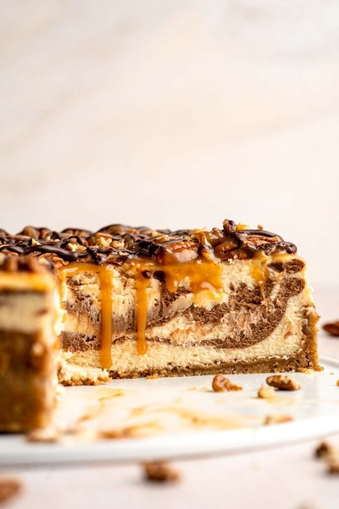 Rich and creamy Turtle Cheesecake with caramel, chocolate, and pecans is a decadent baked dessert with a buttery graham crust and silky filling. | aheadofthyme.com