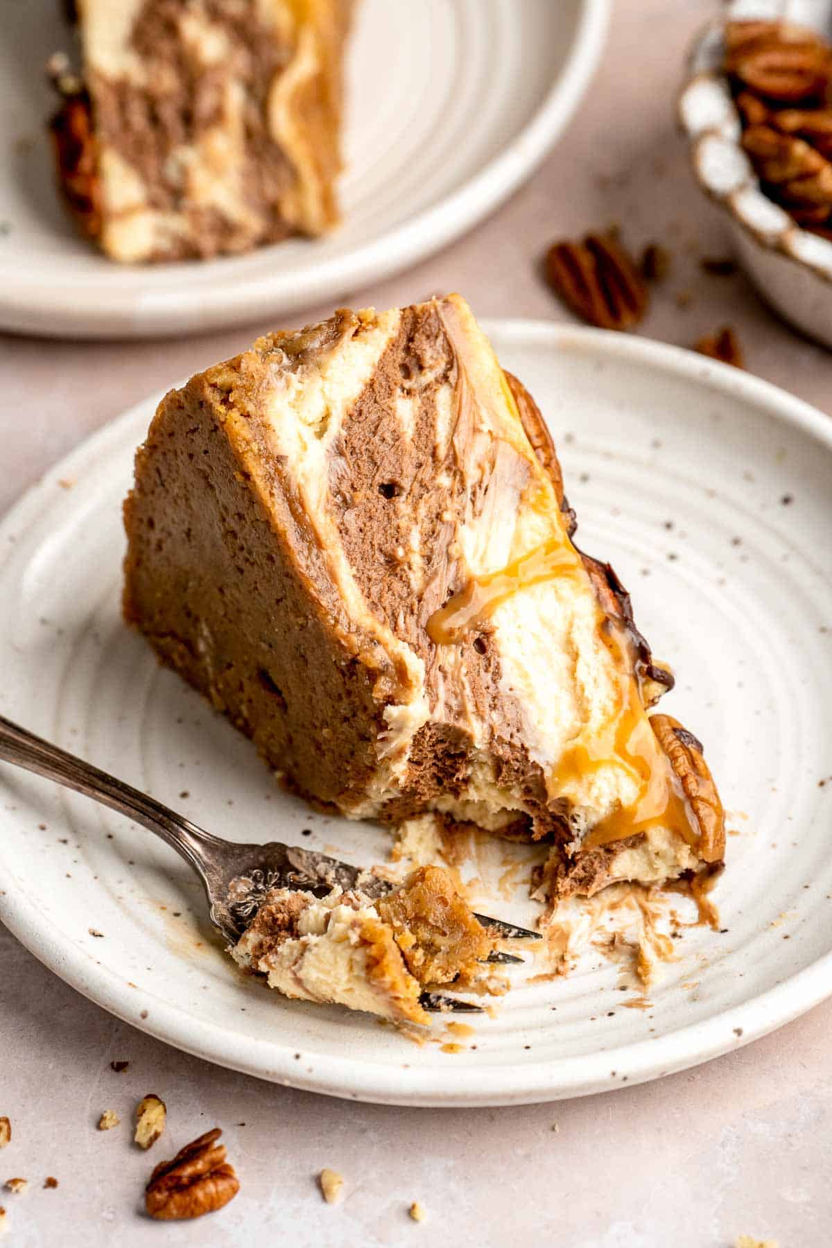Rich and creamy Turtle Cheesecake with caramel, chocolate, and pecans is a decadent baked dessert with a buttery graham crust and silky filling. | aheadofthyme.com