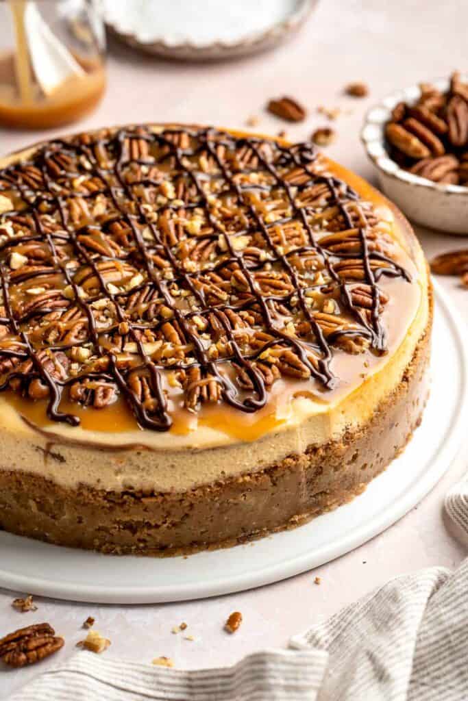 Rich and creamy Turtle Cheesecake with caramel, chocolate, and pecans is a decadent baked dessert with a buttery graham crust and silky filling. | aheadofthyme.com