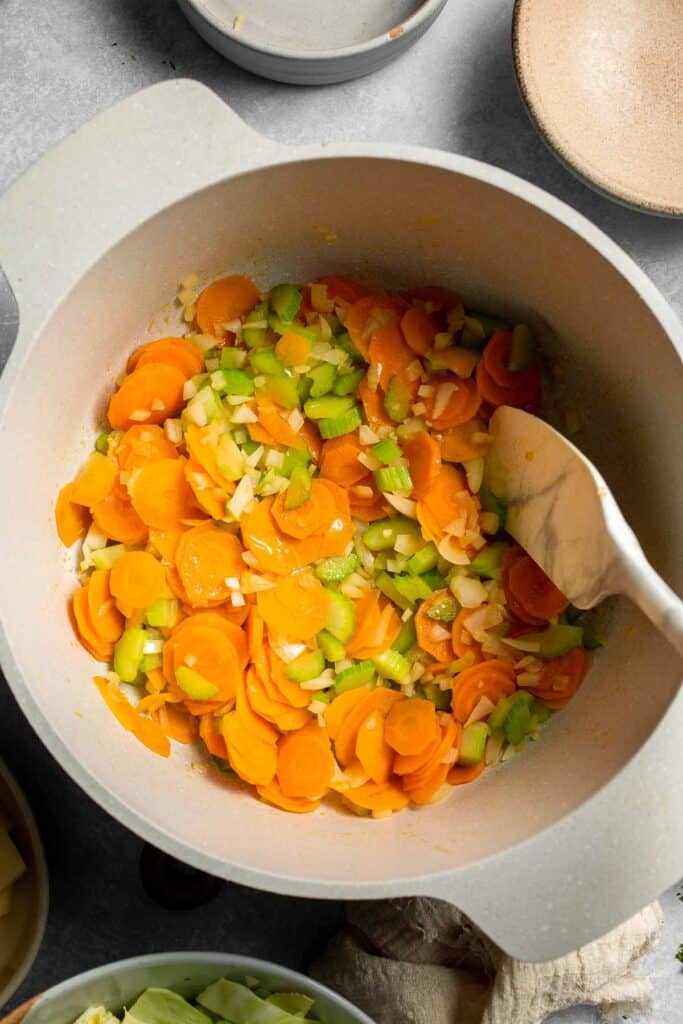 Warm up with this hearty and healthy vegetable cabbage soup packed with potatoes and carrots. A cozy one-pot meal ready in 30 minutes. | aheadofthyme.com