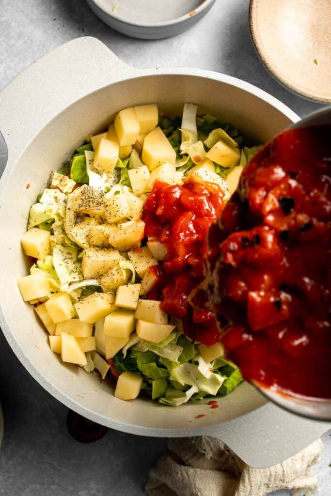 Warm up with this hearty and healthy vegetable cabbage soup packed with potatoes and carrots. A cozy one-pot meal ready in 30 minutes. | aheadofthyme.com