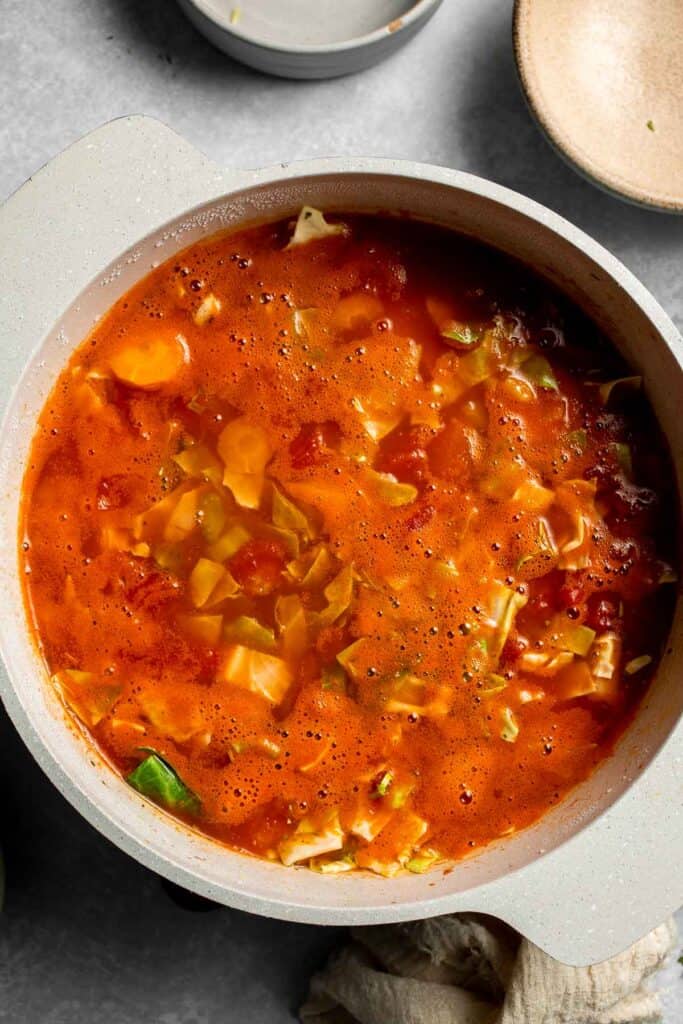 Warm up with this hearty and healthy vegetable cabbage soup packed with potatoes and carrots. A cozy one-pot meal ready in 30 minutes. | aheadofthyme.com