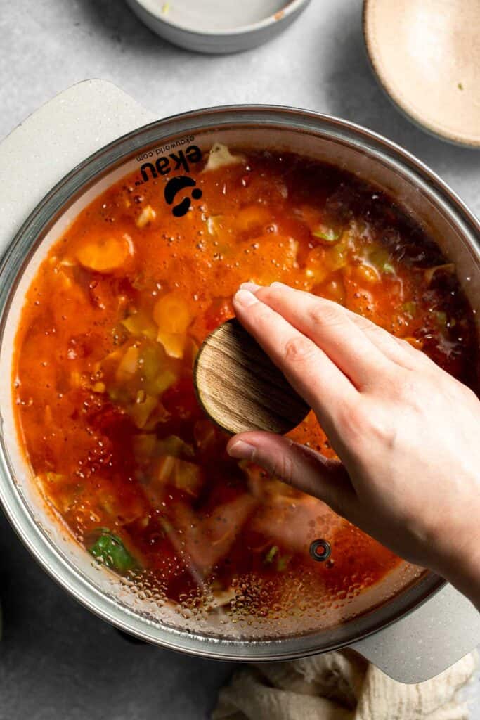 Warm up with this hearty and healthy vegetable cabbage soup packed with potatoes and carrots. A cozy one-pot meal ready in 30 minutes. | aheadofthyme.com