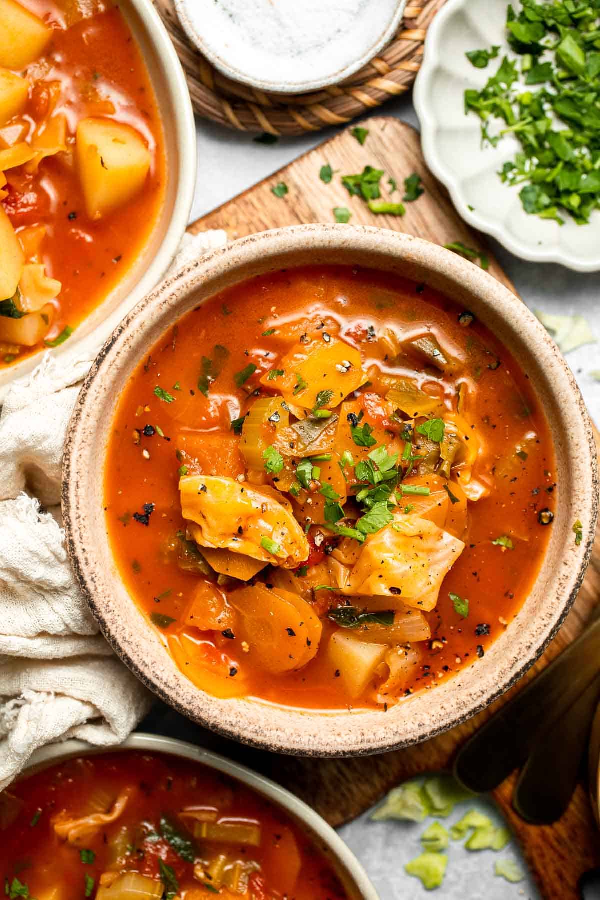 Warm up with this hearty and healthy vegetable cabbage soup packed with potatoes and carrots. A cozy one-pot meal ready in 30 minutes. | aheadofthyme.com