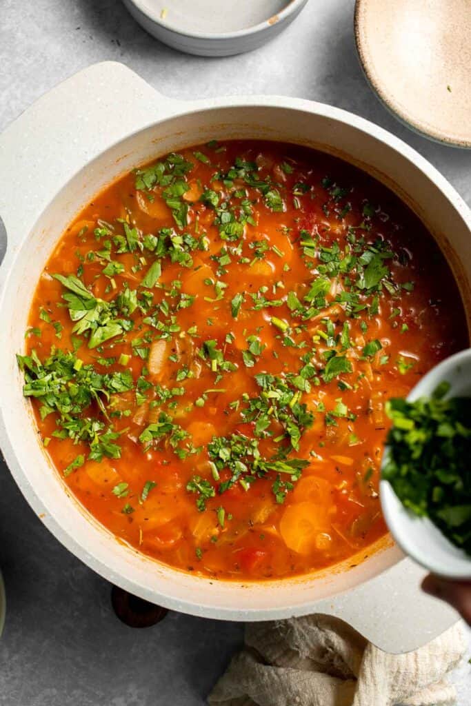 Warm up with this hearty and healthy vegetable cabbage soup packed with potatoes and carrots. A cozy one-pot meal ready in 30 minutes. | aheadofthyme.com