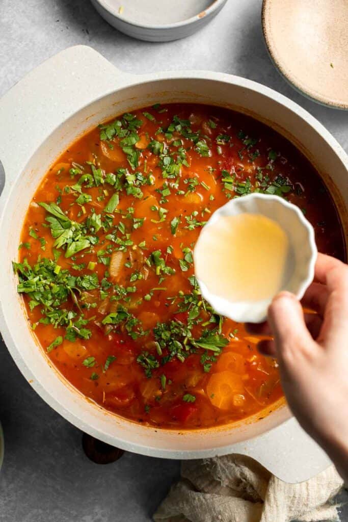 Warm up with this hearty and healthy vegetable cabbage soup packed with potatoes and carrots. A cozy one-pot meal ready in 30 minutes. | aheadofthyme.com