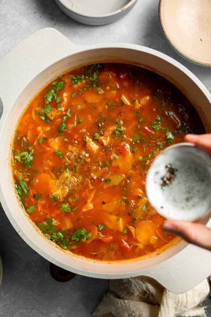 Warm up with this hearty and healthy vegetable cabbage soup packed with potatoes and carrots. A cozy one-pot meal ready in 30 minutes. | aheadofthyme.com