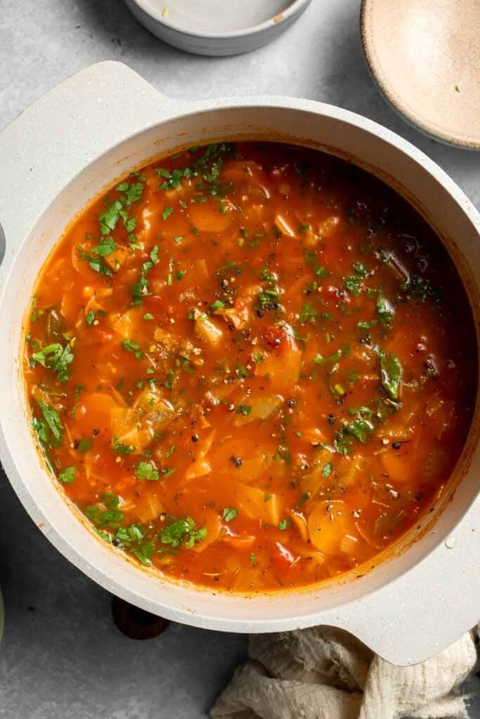 Warm up with this hearty and healthy vegetable cabbage soup packed with potatoes and carrots. A cozy one-pot meal ready in 30 minutes. | aheadofthyme.com