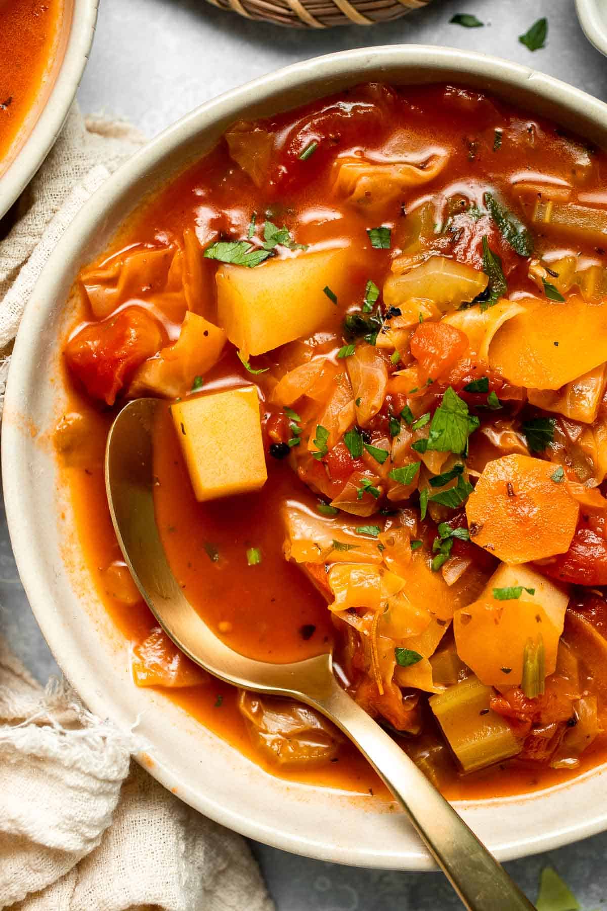 Warm up with this hearty and healthy vegetable cabbage soup packed with potatoes and carrots. A cozy one-pot meal ready in 30 minutes. | aheadofthyme.com