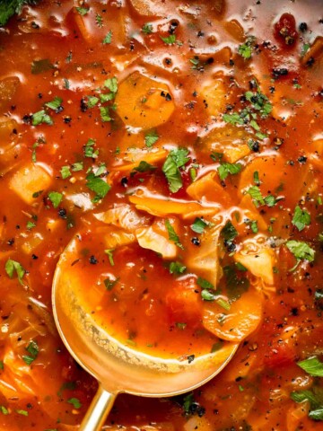 Warm up with this hearty and healthy vegetable cabbage soup packed with potatoes and carrots. A cozy one-pot meal ready in 30 minutes. | aheadofthyme.com