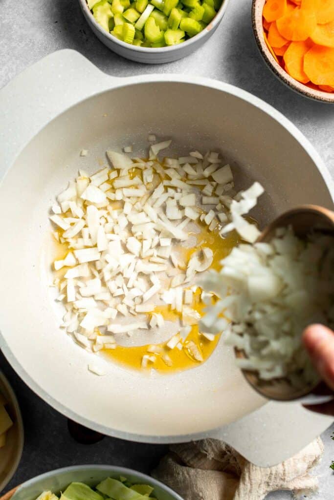 Warm up with this hearty and healthy vegetable cabbage soup packed with potatoes and carrots. A cozy one-pot meal ready in 30 minutes. | aheadofthyme.com