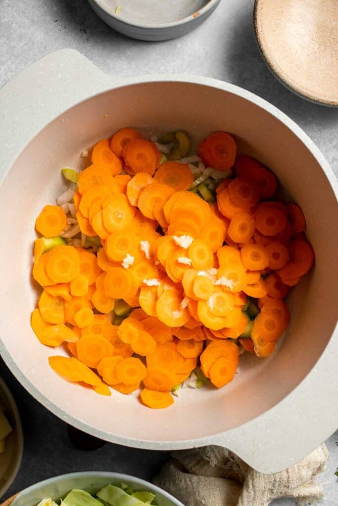 Warm up with this hearty and healthy vegetable cabbage soup packed with potatoes and carrots. A cozy one-pot meal ready in 30 minutes. | aheadofthyme.com