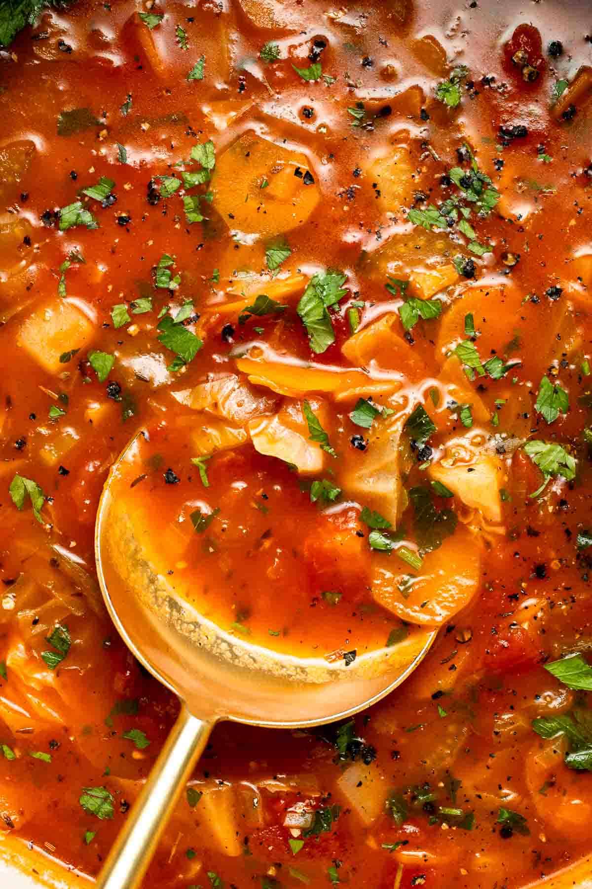 Warm up with this hearty and healthy vegetable cabbage soup packed with potatoes and carrots. A cozy one-pot meal ready in 30 minutes. | aheadofthyme.com