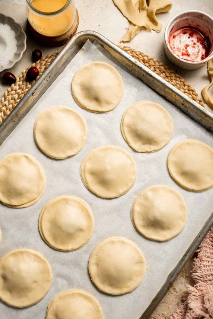Cranberry Hand Pies are buttery, flaky, and filled with leftover cranberry sauce. An easy, festive holiday dessert perfect for Thanksgiving or Christmas. | aheadofthyme.com