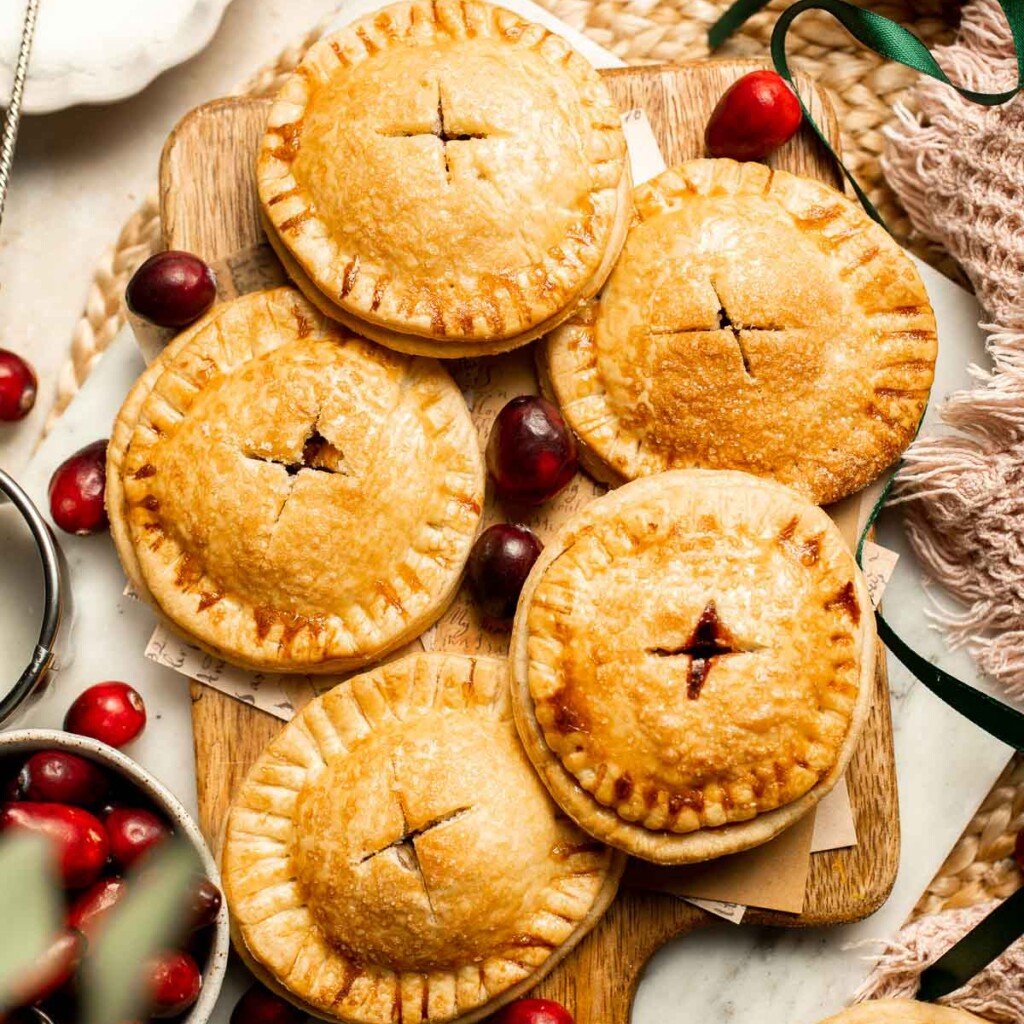Cranberry Hand Pies are buttery, flaky, and filled with leftover cranberry sauce. An easy, festive holiday dessert perfect for Thanksgiving or Christmas. | aheadofthyme.com