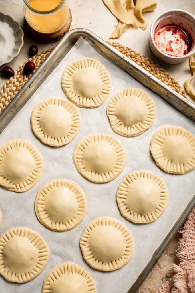 Cranberry Hand Pies are buttery, flaky, and filled with leftover cranberry sauce. An easy, festive holiday dessert perfect for Thanksgiving or Christmas. | aheadofthyme.com