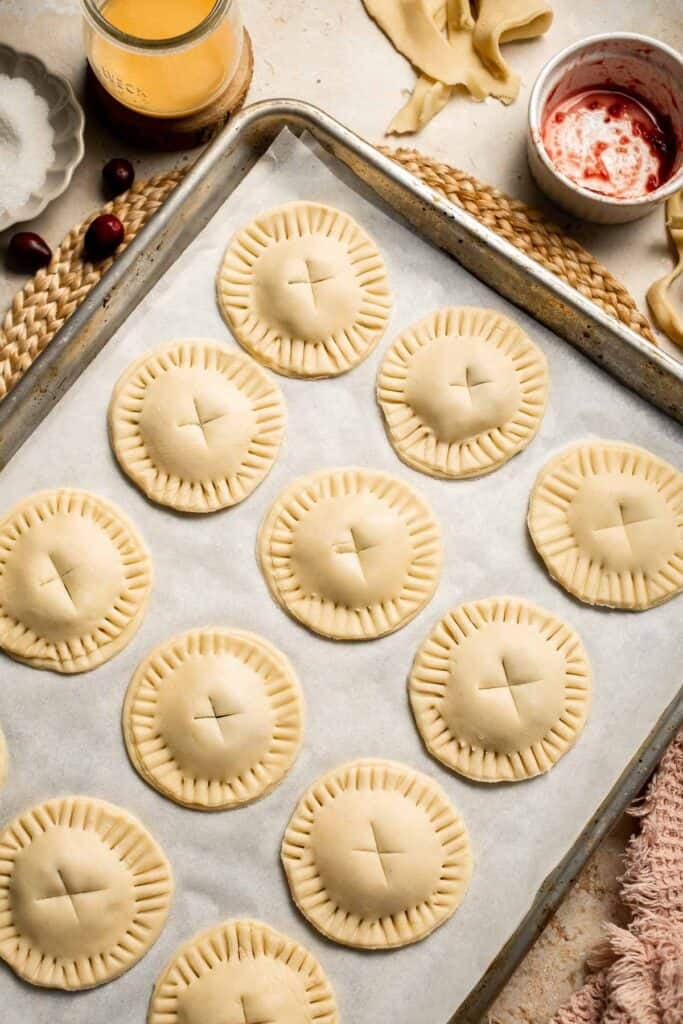 Cranberry Hand Pies are buttery, flaky, and filled with leftover cranberry sauce. An easy, festive holiday dessert perfect for Thanksgiving or Christmas. | aheadofthyme.com