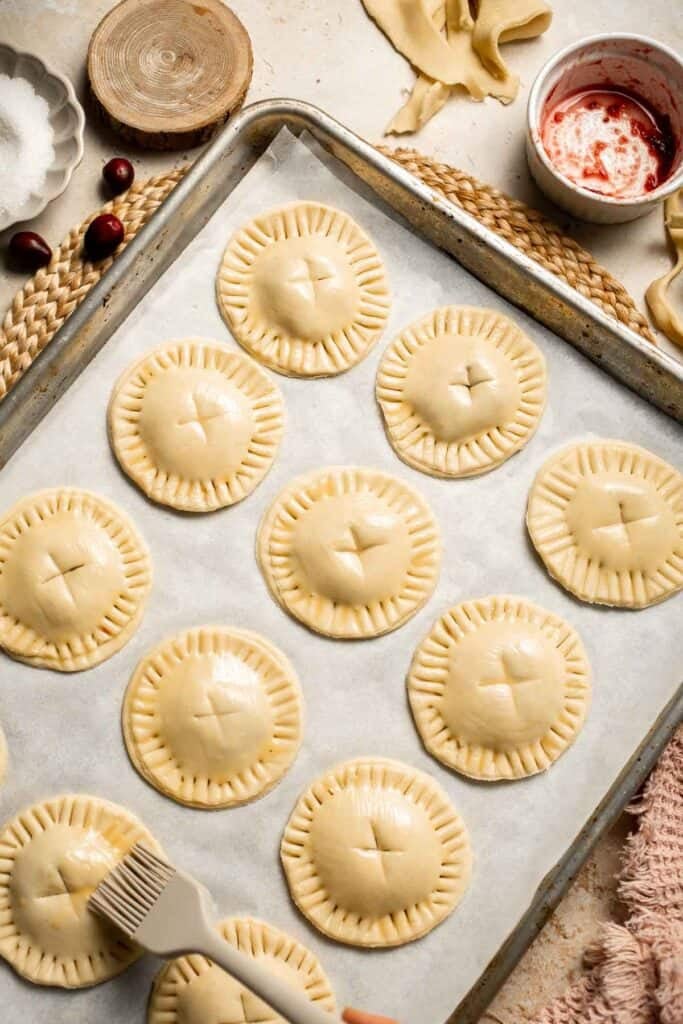 Cranberry Hand Pies are buttery, flaky, and filled with leftover cranberry sauce. An easy, festive holiday dessert perfect for Thanksgiving or Christmas. | aheadofthyme.com