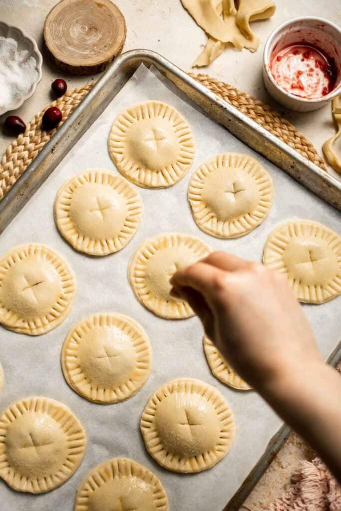 Cranberry Hand Pies are buttery, flaky, and filled with leftover cranberry sauce. An easy, festive holiday dessert perfect for Thanksgiving or Christmas. | aheadofthyme.com