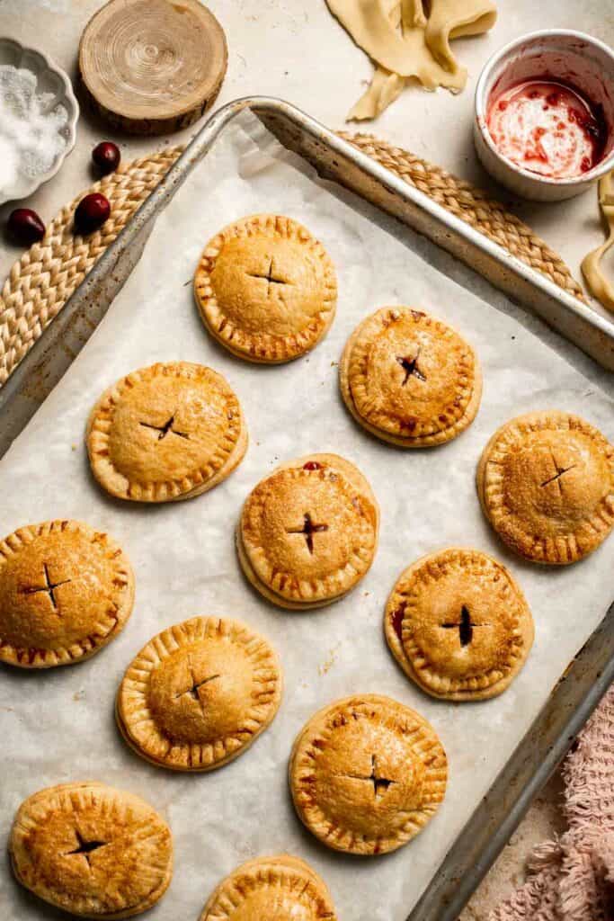 Cranberry Hand Pies are buttery, flaky, and filled with leftover cranberry sauce. An easy, festive holiday dessert perfect for Thanksgiving or Christmas. | aheadofthyme.com