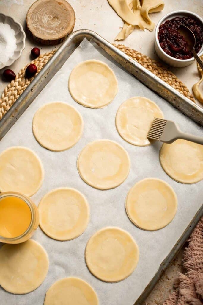 Cranberry Hand Pies are buttery, flaky, and filled with leftover cranberry sauce. An easy, festive holiday dessert perfect for Thanksgiving or Christmas. | aheadofthyme.com