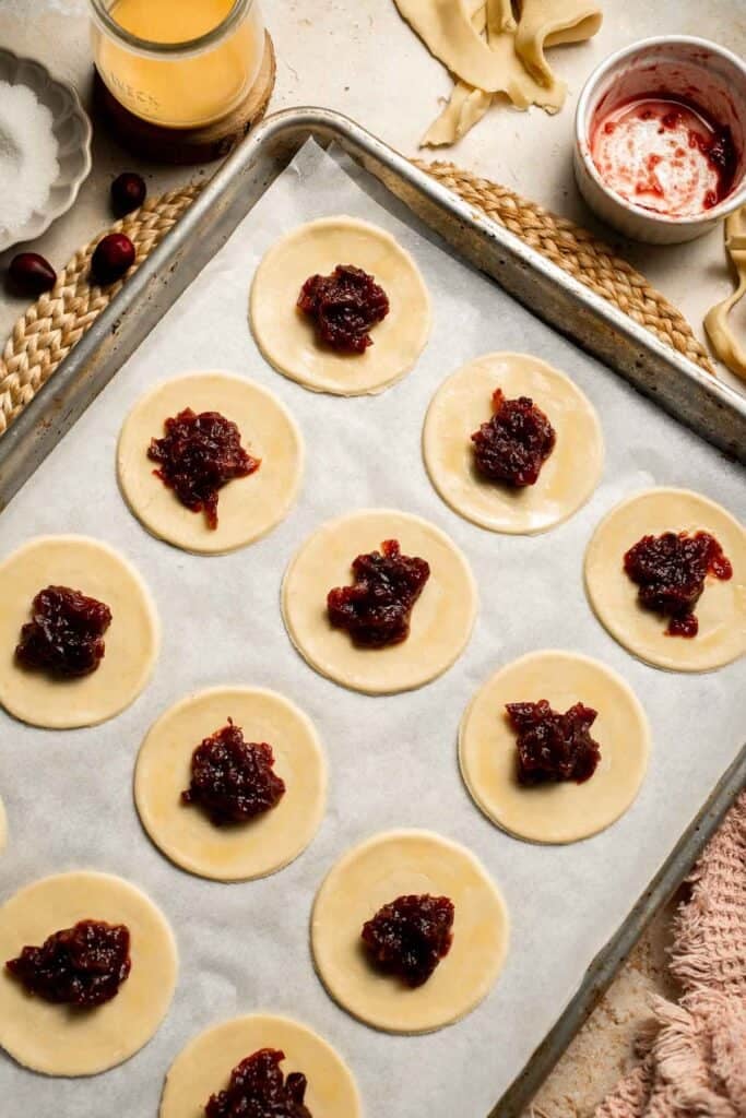 Cranberry Hand Pies are buttery, flaky, and filled with leftover cranberry sauce. An easy, festive holiday dessert perfect for Thanksgiving or Christmas. | aheadofthyme.com