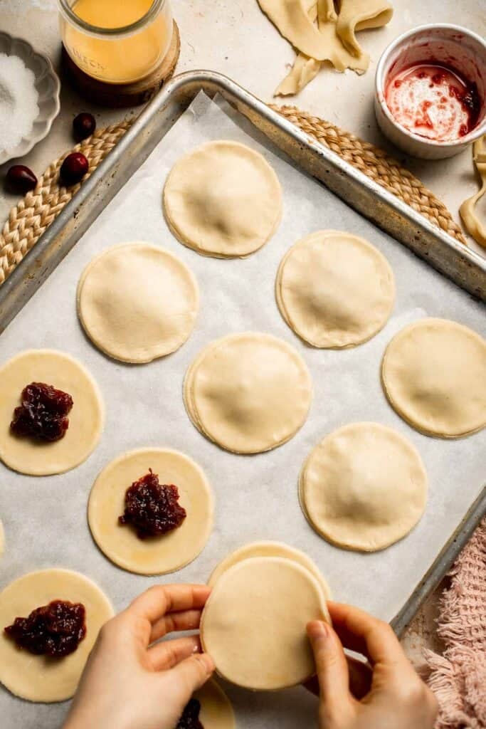 Cranberry Hand Pies are buttery, flaky, and filled with leftover cranberry sauce. An easy, festive holiday dessert perfect for Thanksgiving or Christmas. | aheadofthyme.com