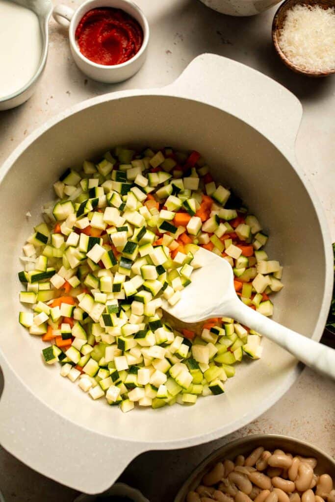 Creamy Tortellini Minestrone Soup is hearty, cozy, and loaded with veggies, beans, and cheese tortellini in a rich tomato-cream broth. | aheadofthyme.com