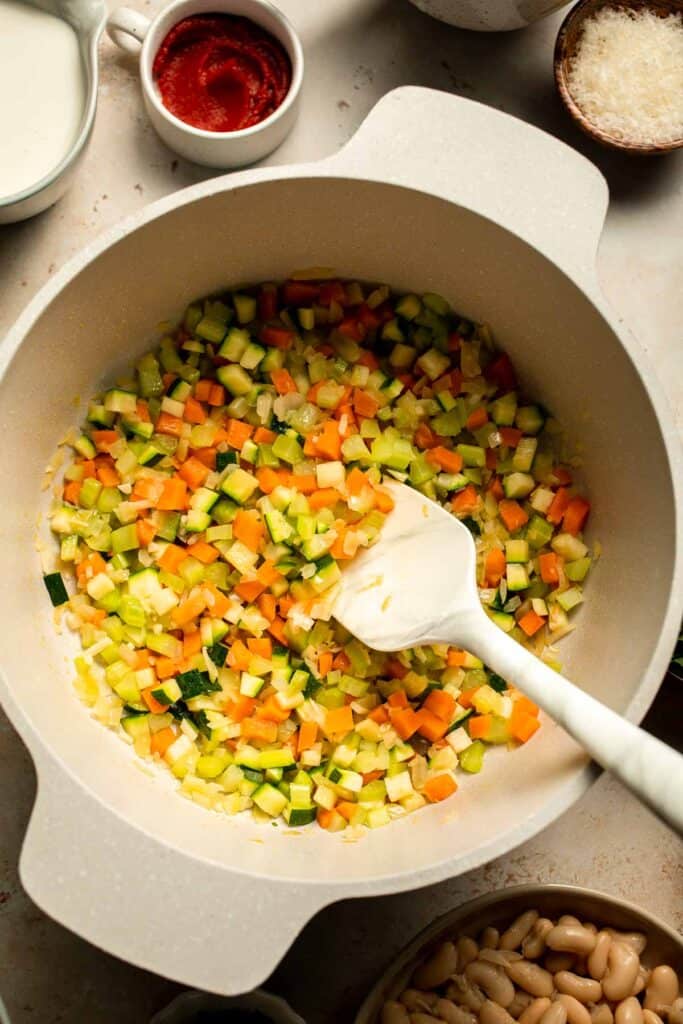 Creamy Tortellini Minestrone Soup is hearty, cozy, and loaded with veggies, beans, and cheese tortellini in a rich tomato-cream broth. | aheadofthyme.com