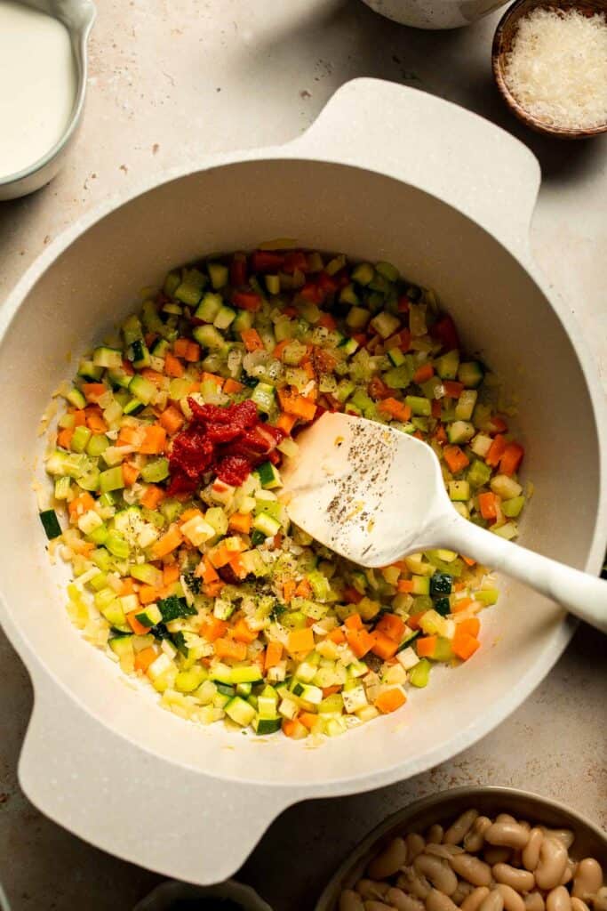 Creamy Tortellini Minestrone Soup is hearty, cozy, and loaded with veggies, beans, and cheese tortellini in a rich tomato-cream broth. | aheadofthyme.com