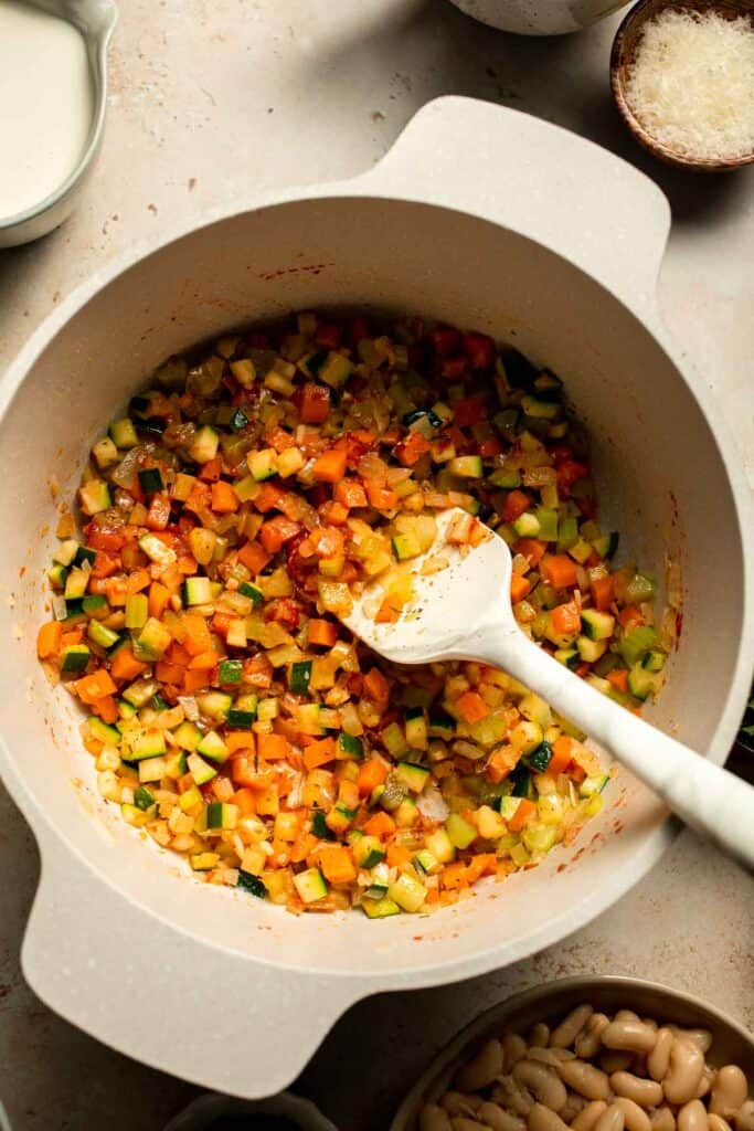 Creamy Tortellini Minestrone Soup is hearty, cozy, and loaded with veggies, beans, and cheese tortellini in a rich tomato-cream broth. | aheadofthyme.com