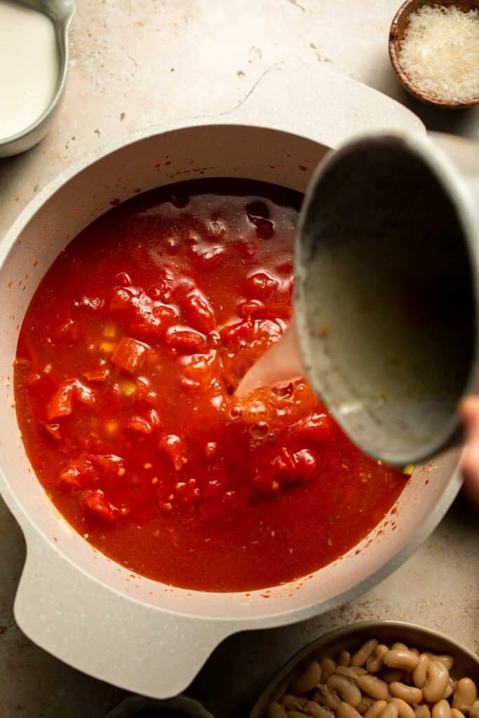 Creamy Tortellini Minestrone Soup is hearty, cozy, and loaded with veggies, beans, and cheese tortellini in a rich tomato-cream broth. | aheadofthyme.com