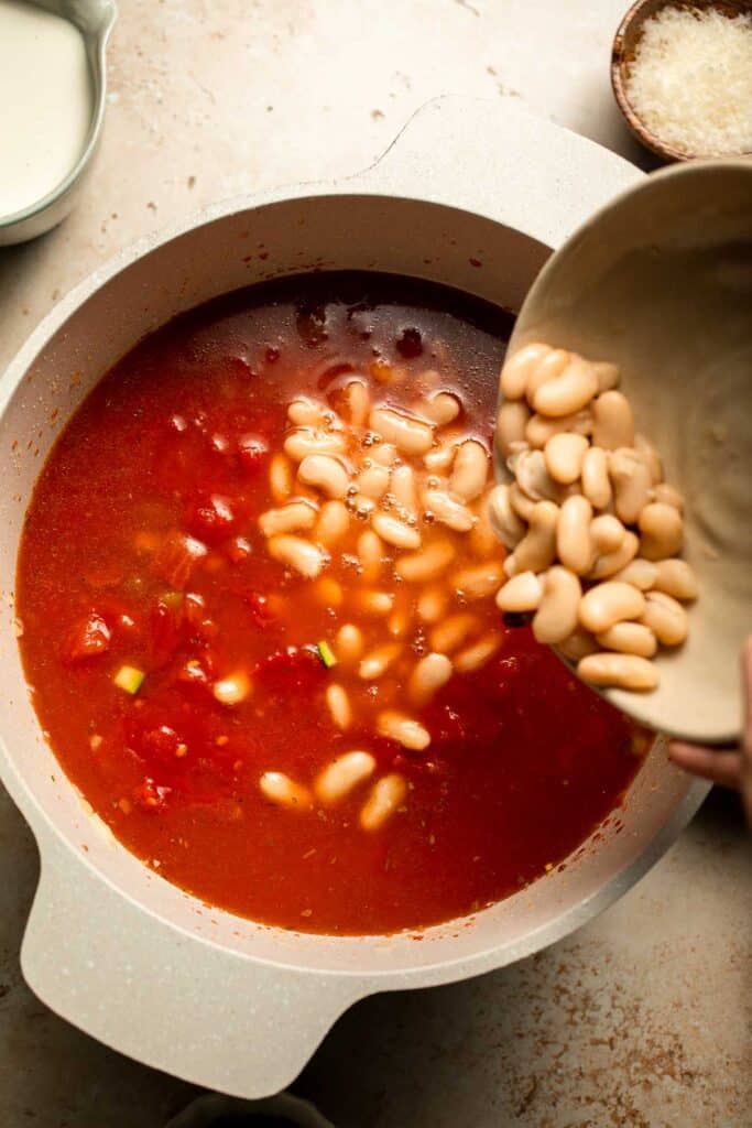 Creamy Tortellini Minestrone Soup is hearty, cozy, and loaded with veggies, beans, and cheese tortellini in a rich tomato-cream broth. | aheadofthyme.com